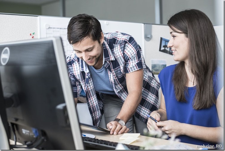 Two young people in a cubicle